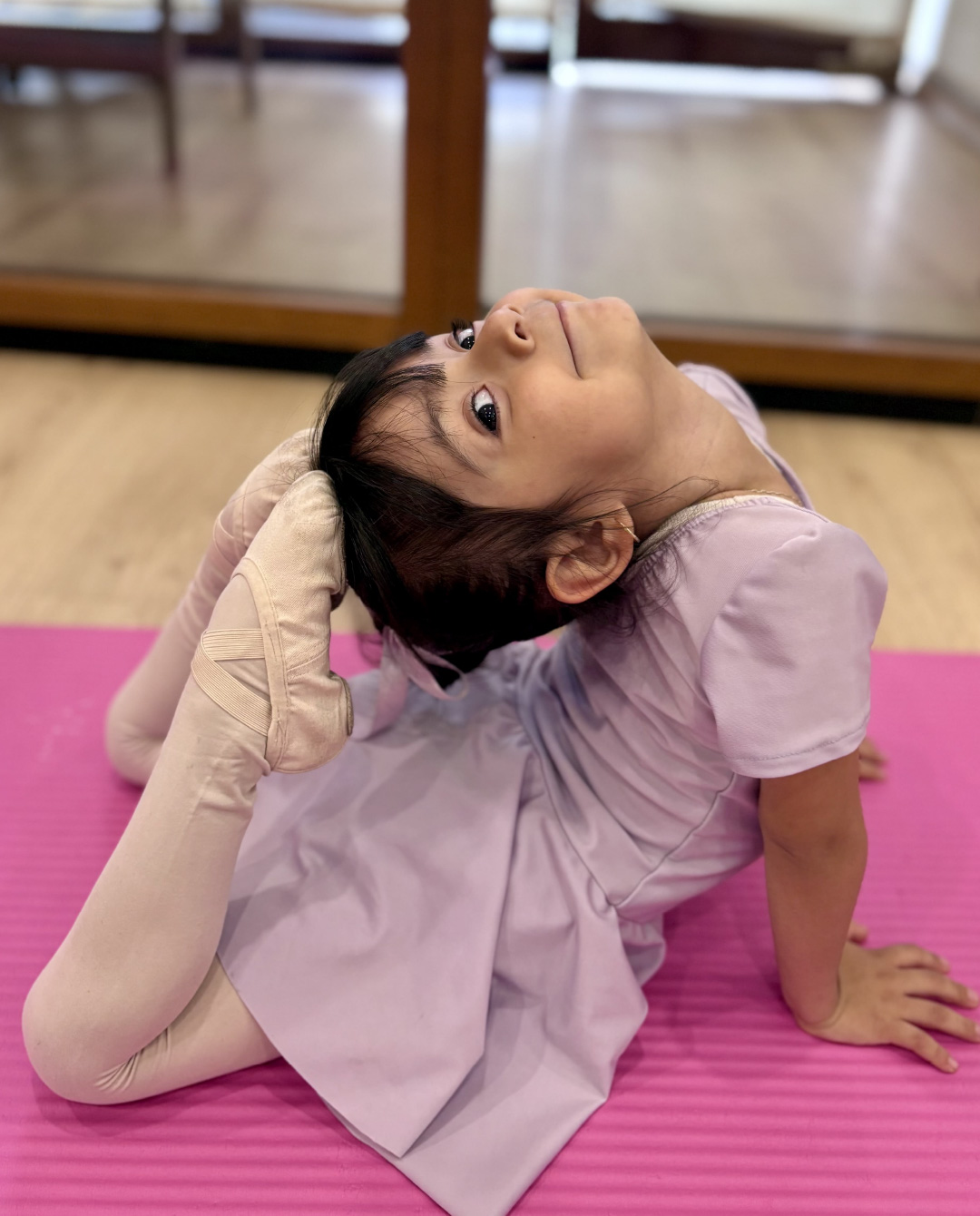 Alumna de Danzarella realizando un ejercicio de flexibilidad durante una clase